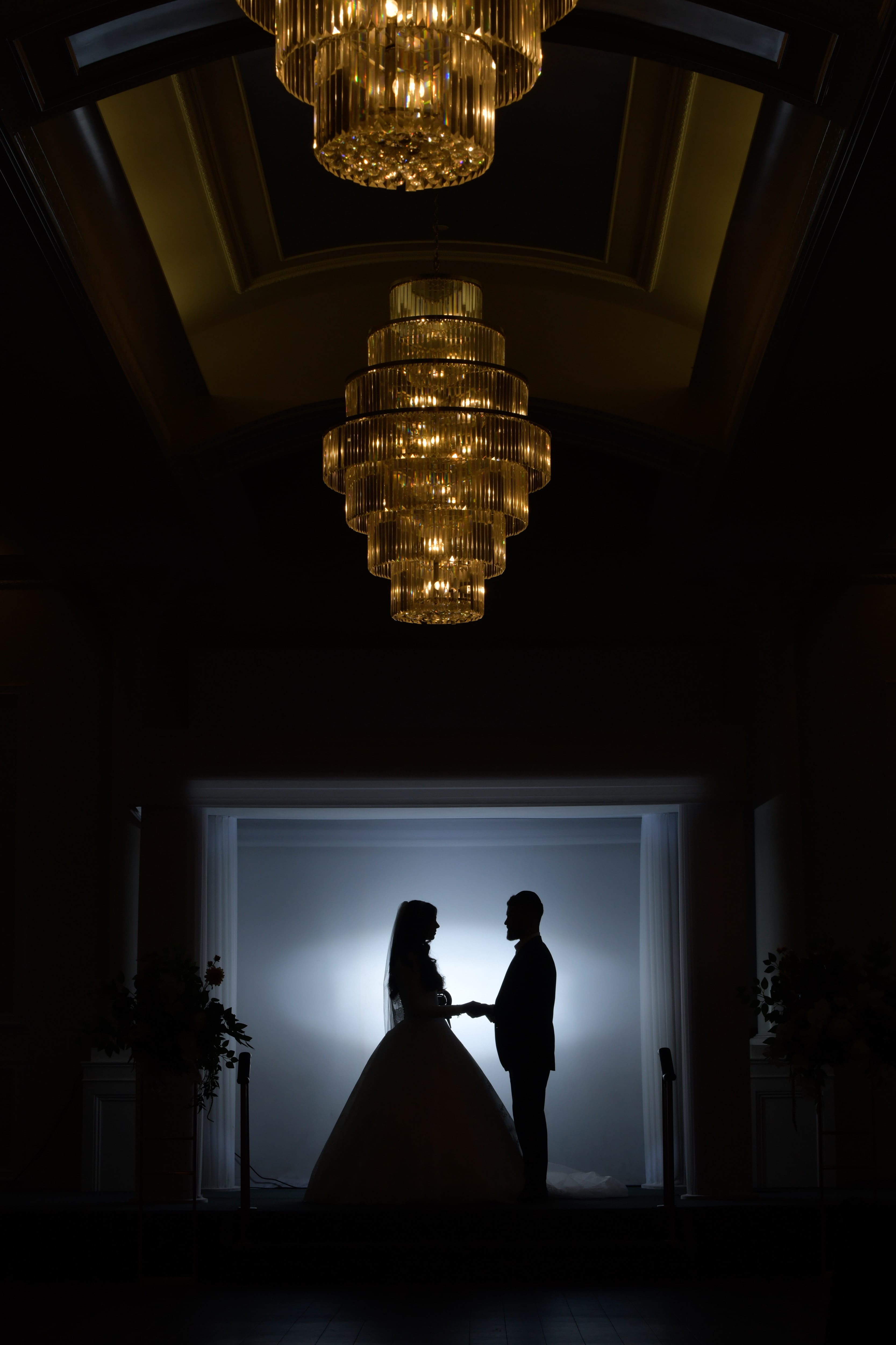 Couple silhouette in doorway with chandelier — a recent Manhattan wedding